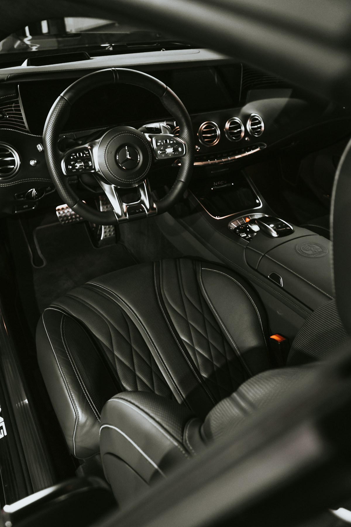 Black leather car interior with a detailed dashboard and centre console